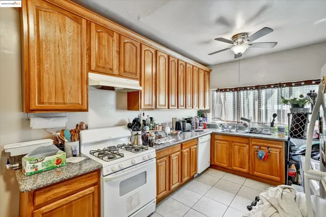 a kitchen with a sink a stove and cabinets