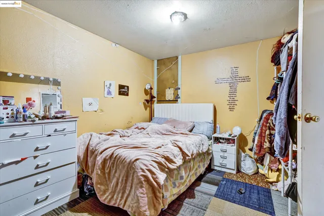 a bedroom with a bed and dresser