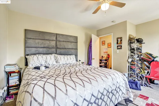 a bedroom with a large bed and a chandelier