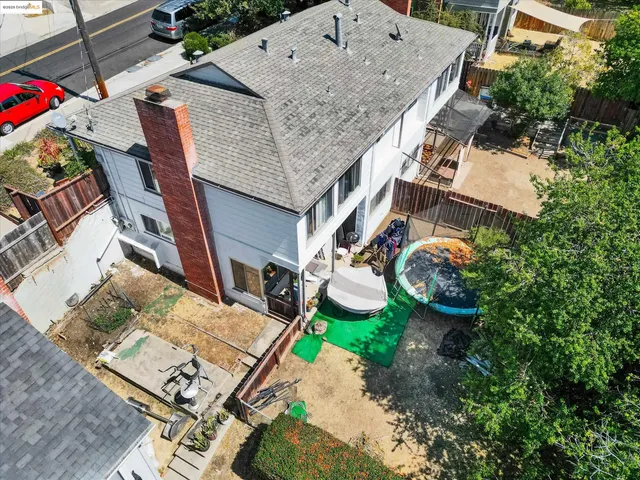 an aerial view of a house with garden space and street view