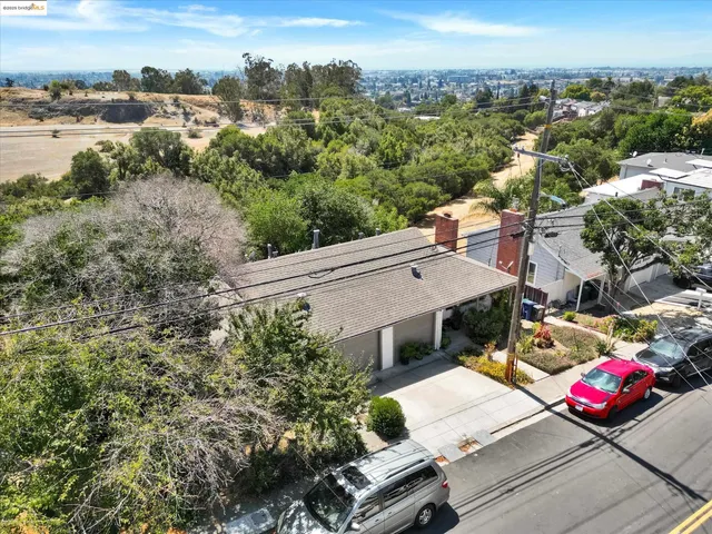 an aerial view of a house with a yard