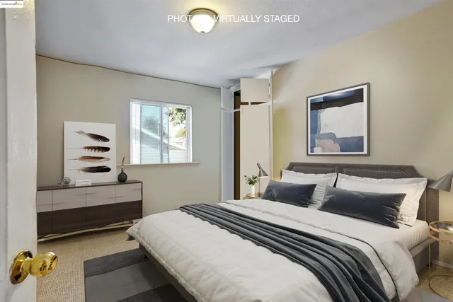 a bedroom with a bed and a window