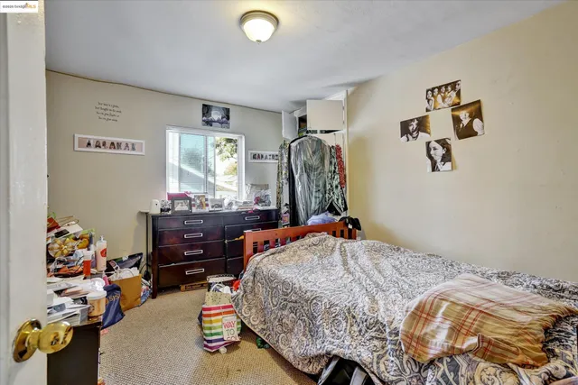 a bedroom with a bed and dresser