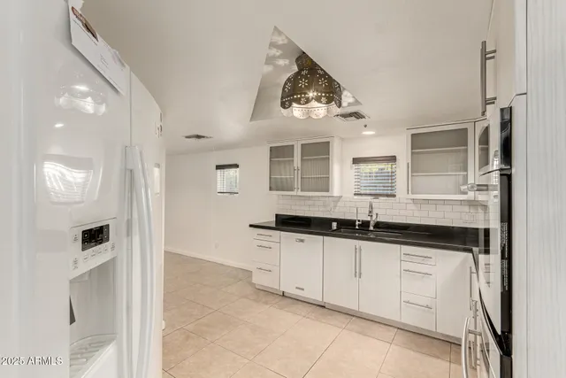a bathroom with a sink mirror and vanity