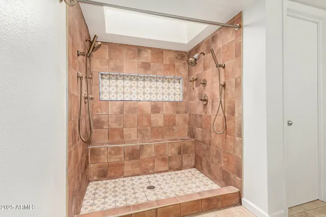 an empty room with a window and a ceiling fan