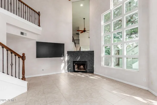 a living room with a fireplace and a flat screen tv