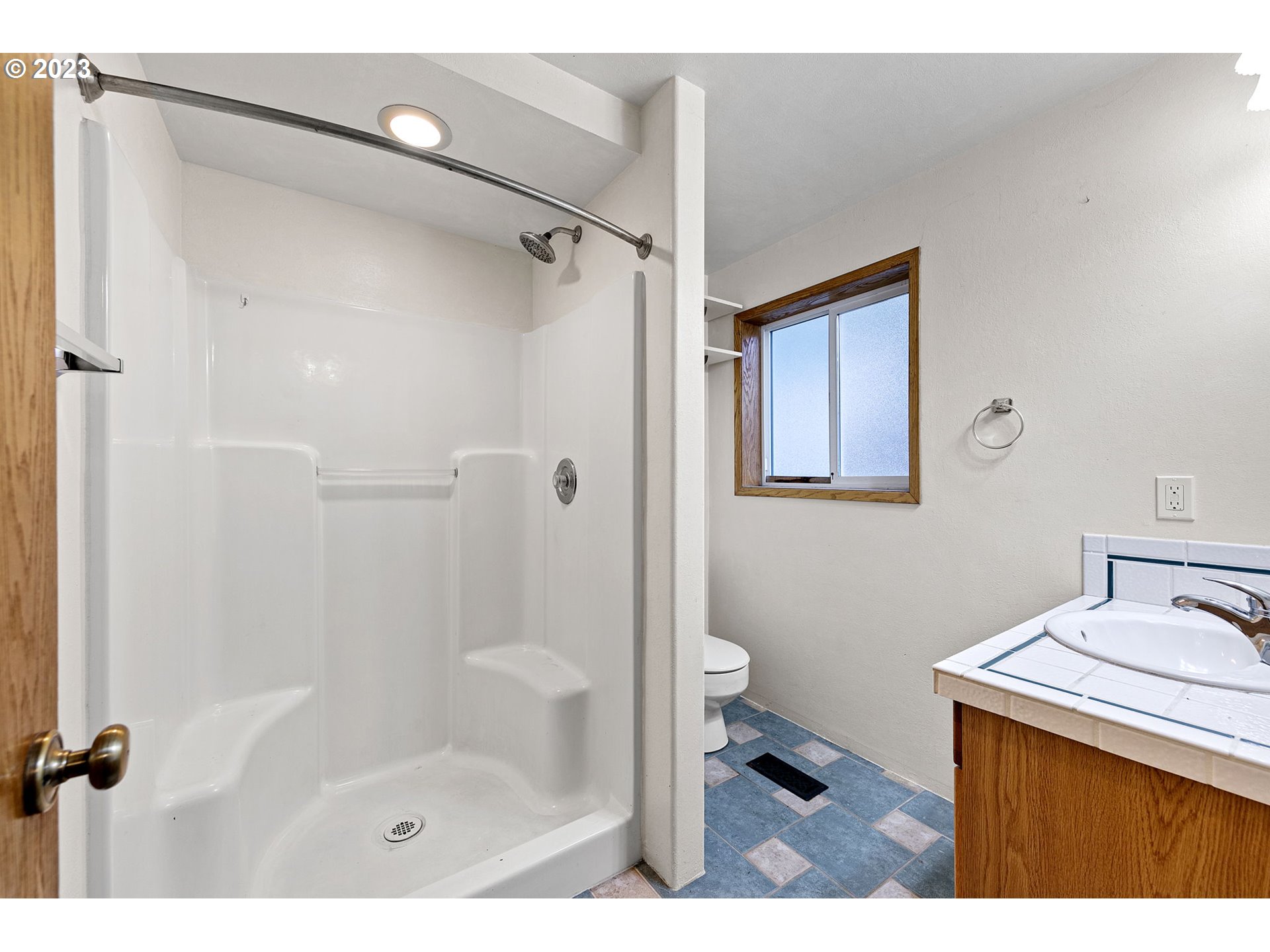 788 70th Street Springfield, OR 97478 - Photo 18 of 39 a bathroom with a shower a sink and a toilet