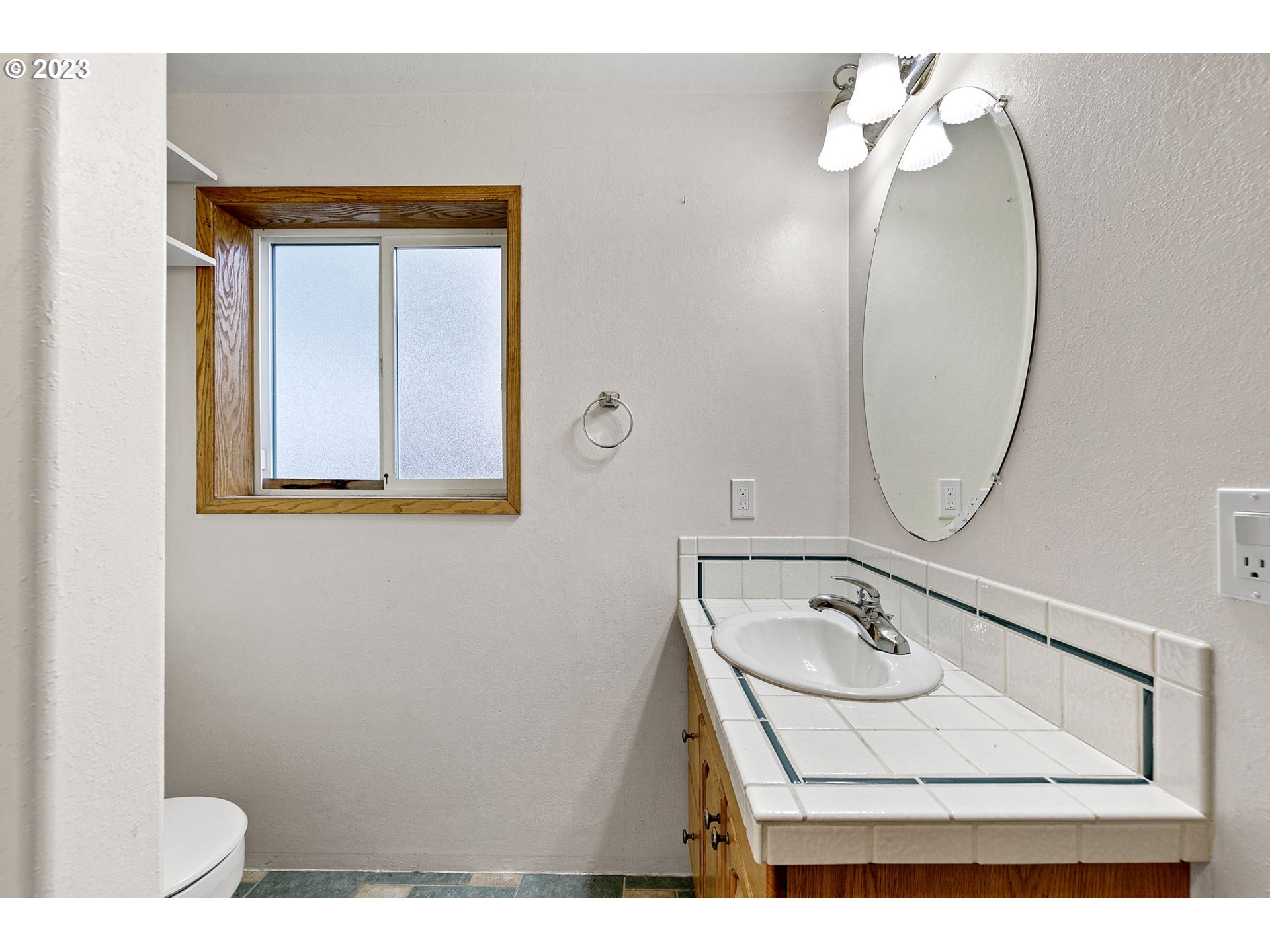 788 70th Street Springfield, OR 97478 - Photo 19 of 39 a bathroom with a sink mirror and vanity
