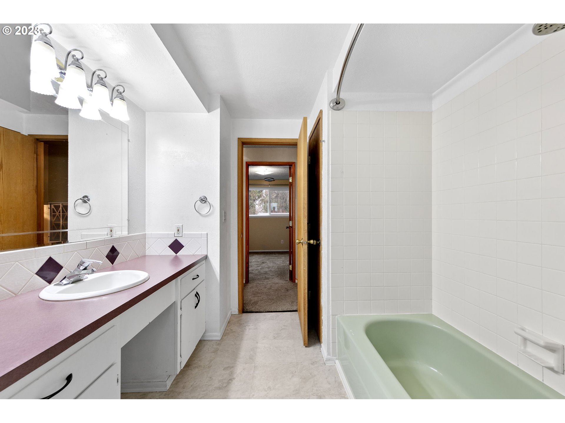 788 70th Street Springfield, OR 97478 - Photo 26 of 39 a bathroom with a sink a mirror and a bathtub