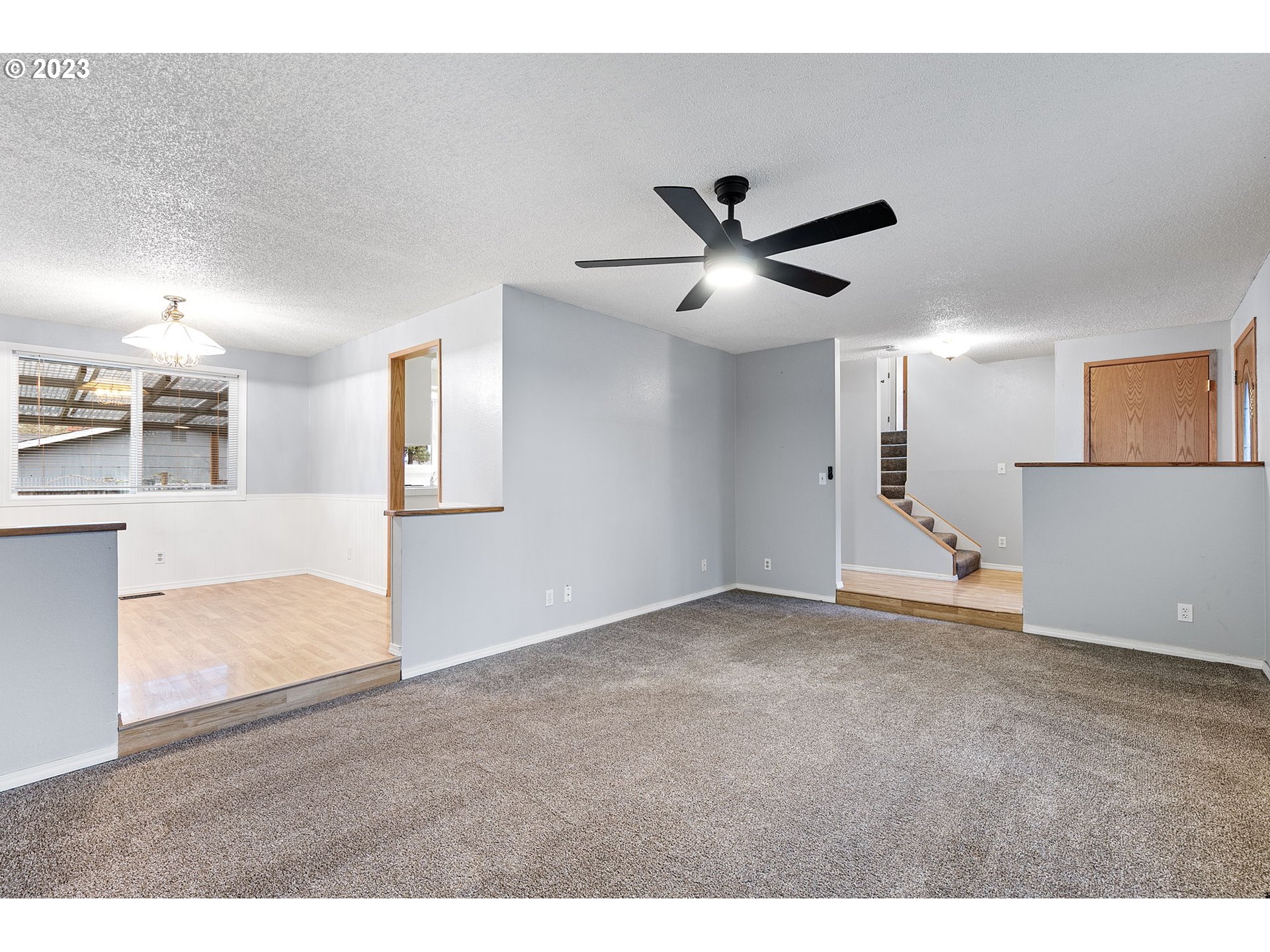 788 70th Street Springfield, OR 97478 - Photo 7 of 39 a view of a big room with wooden floor and a kitchen
