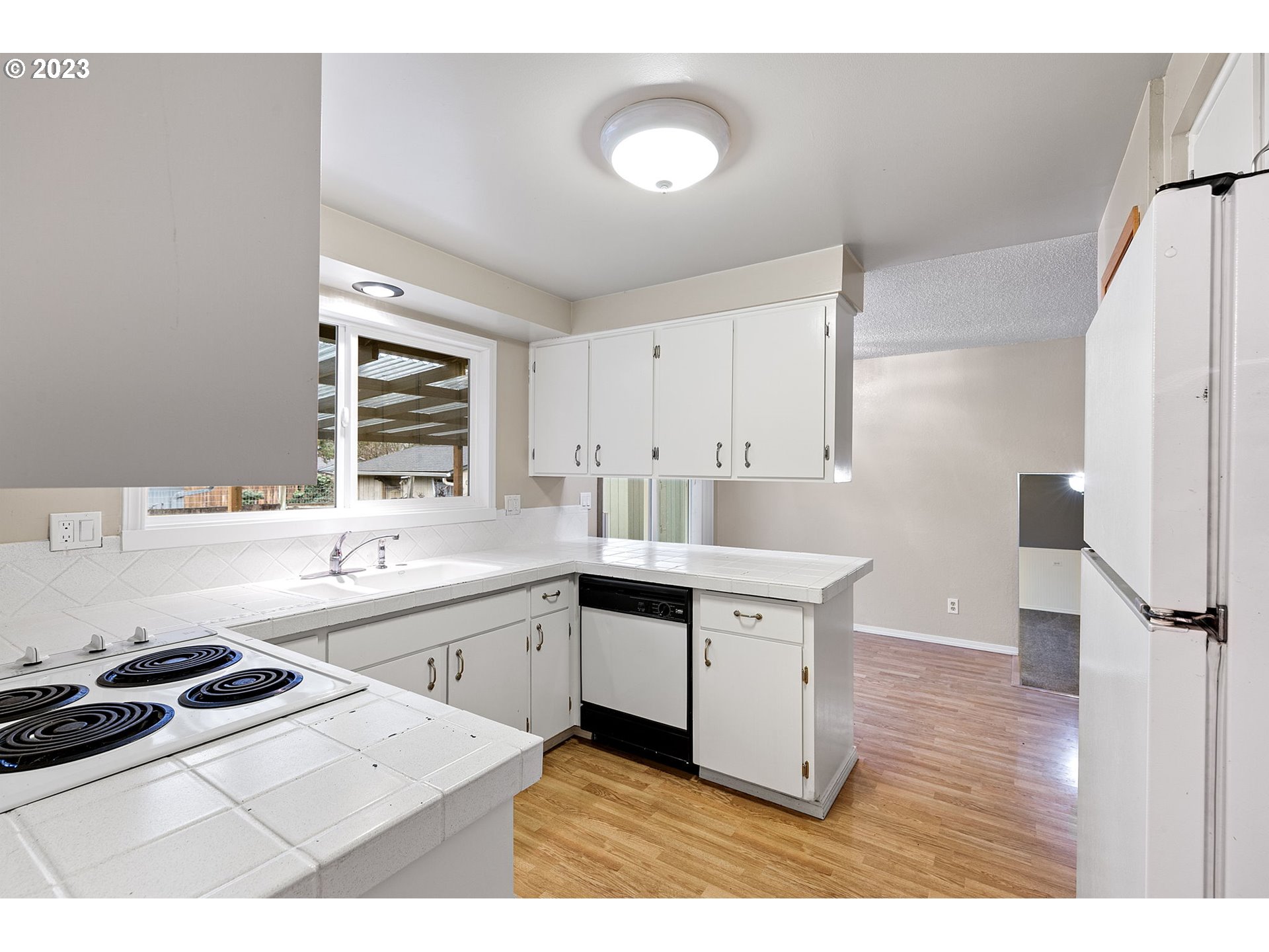 788 70th Street Springfield, OR 97478 - Photo 10 of 39 a kitchen with a stove a sink and a refrigerator