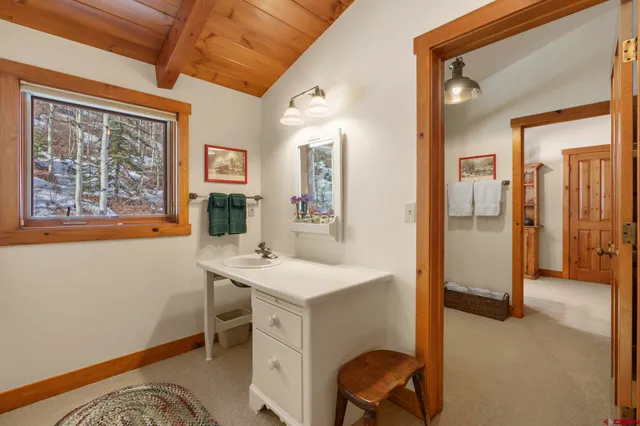 a view of a hallway with workspace and a window