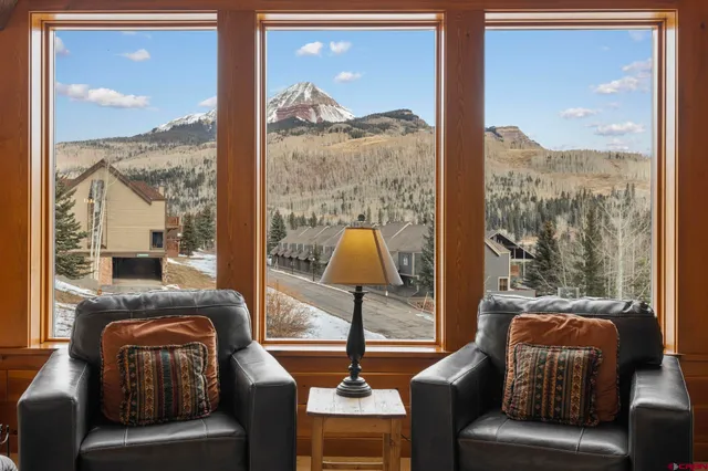 a living room with furniture and a floor to ceiling window