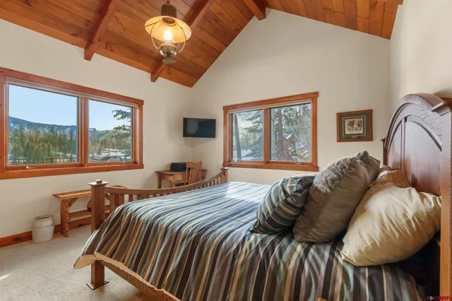 a bedroom with a bed and a large window