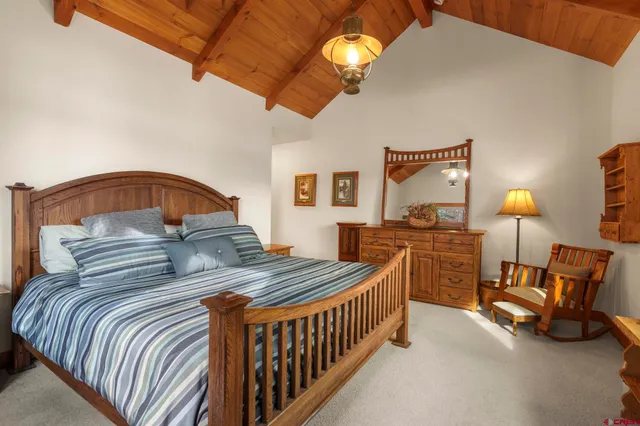 a bedroom with bed and a chandelier