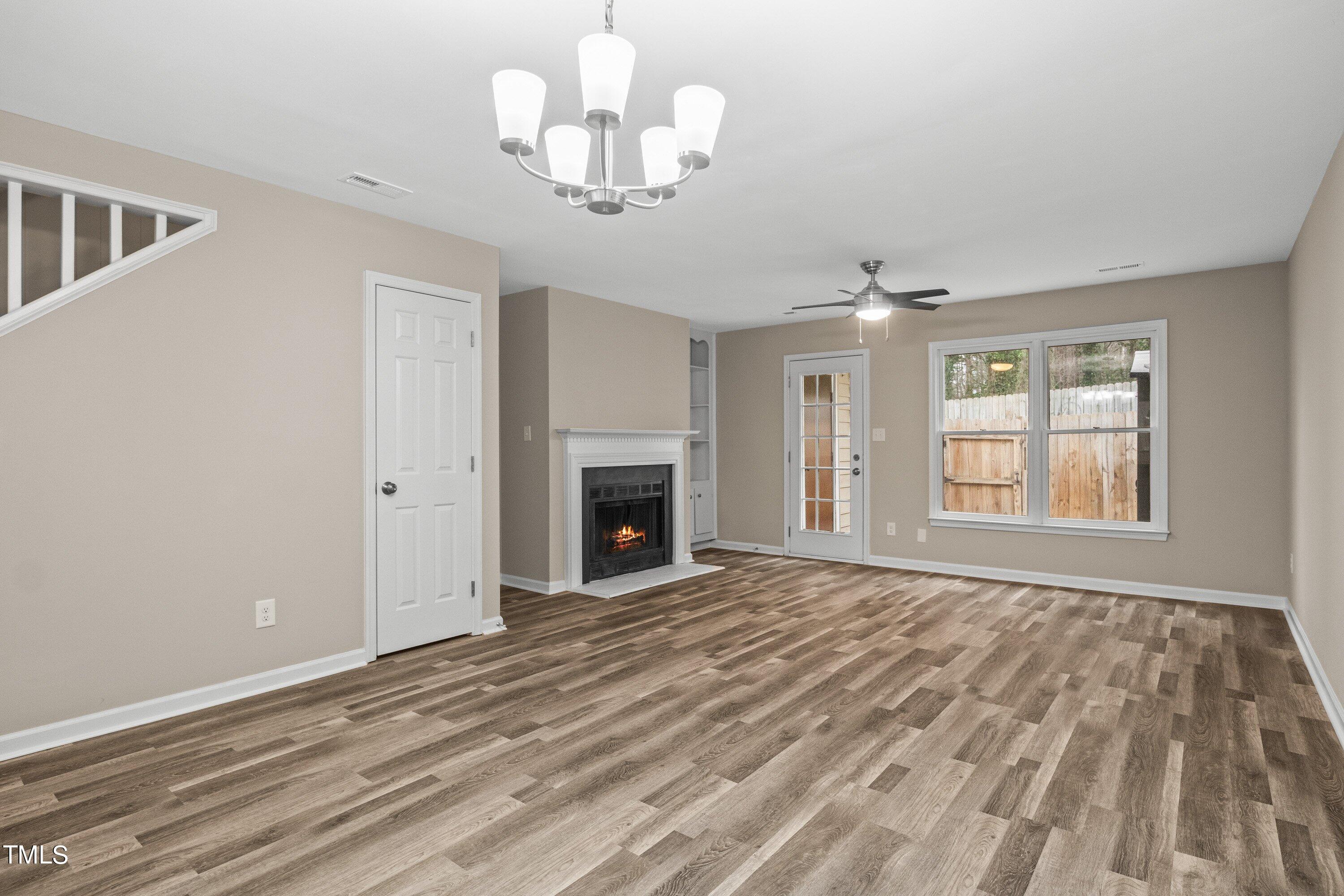 4440 Roller Court Raleigh, NC 27604 - Photo 12 of 38 a view of empty room with wooden floor and fireplace
