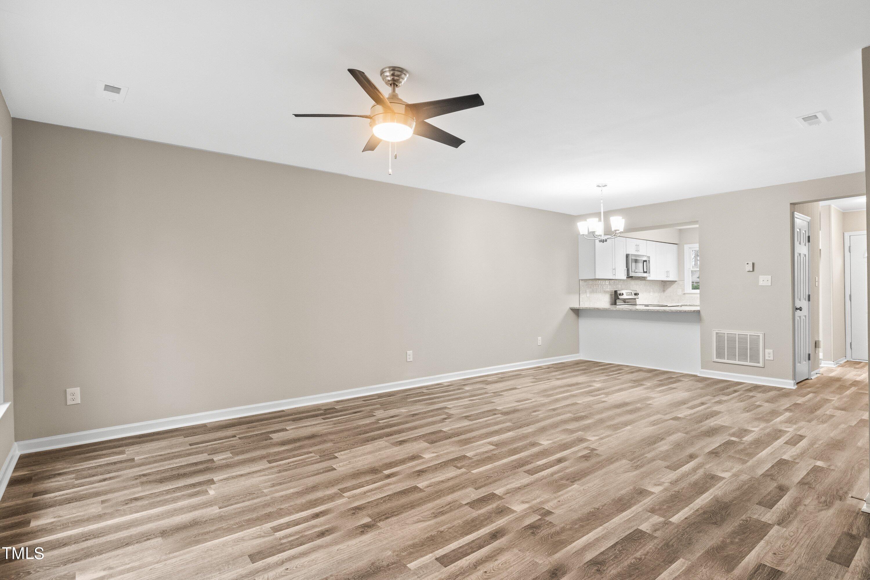 4440 Roller Court Raleigh, NC 27604 - Photo 14 of 38 a view of empty room with wooden floor and window