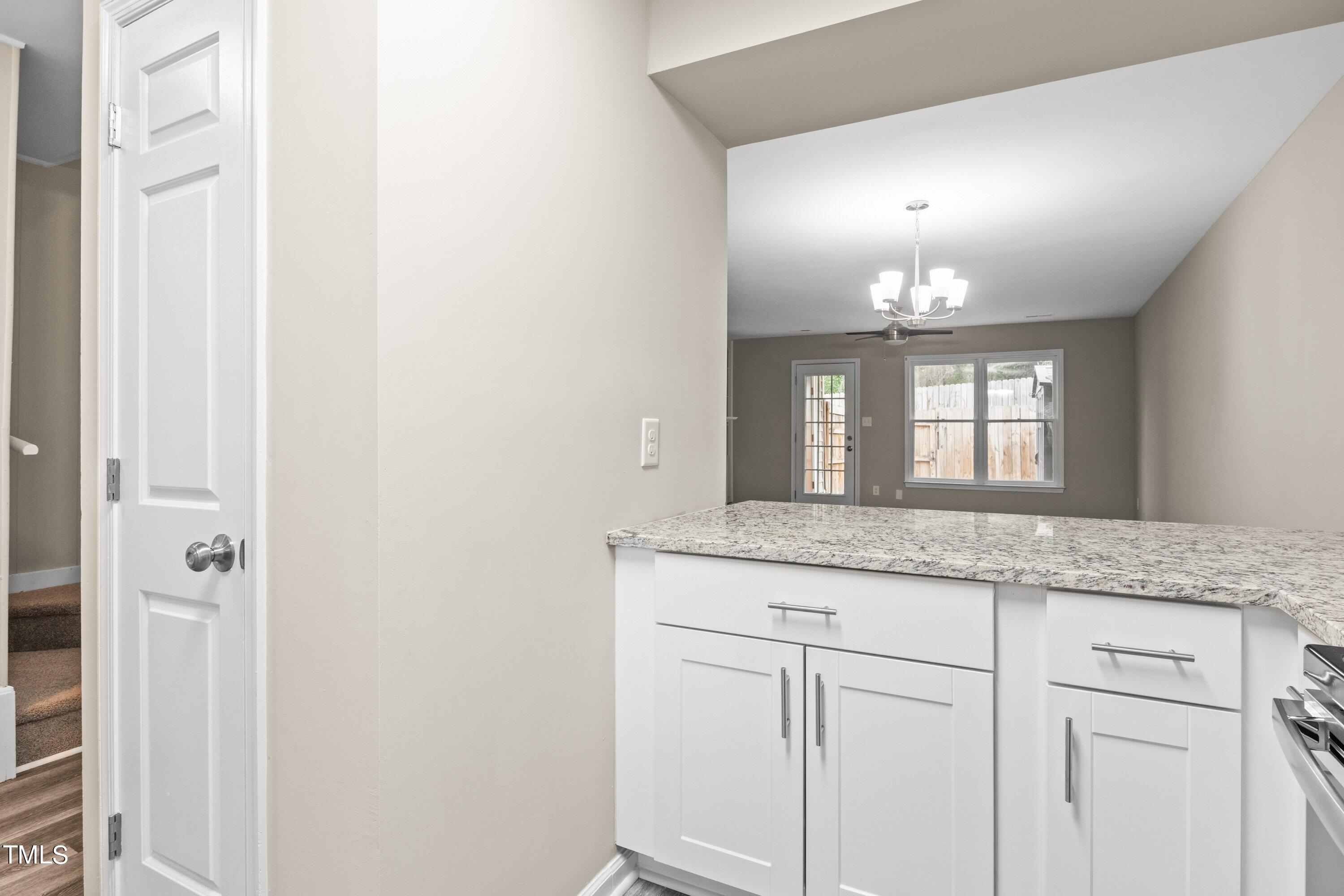 4440 Roller Court Raleigh, NC 27604 - Photo 19 of 38 a bathroom with a granite countertop sink and a mirror