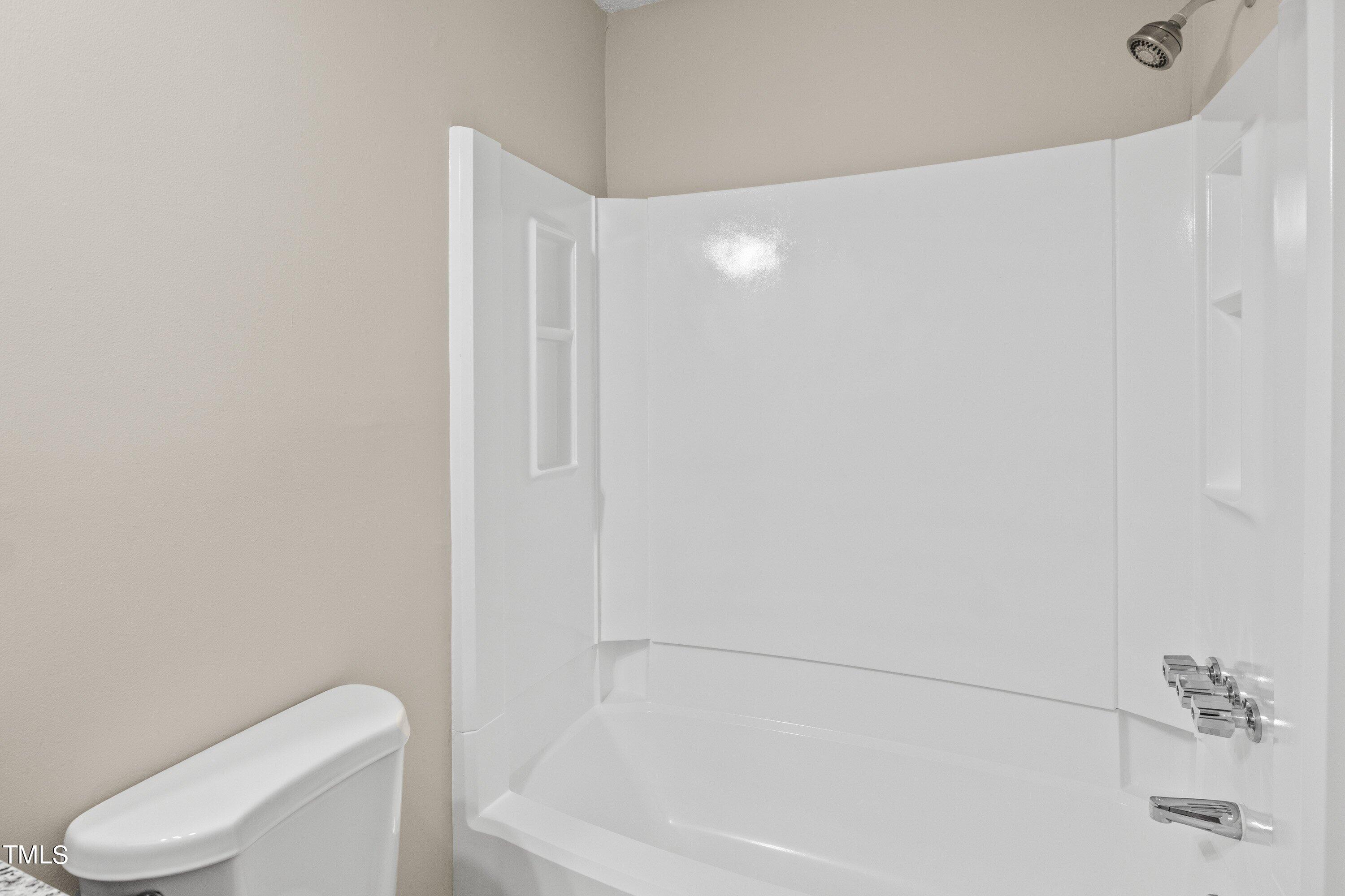 4440 Roller Court Raleigh, NC 27604 - Photo 28 of 38 a bathroom with a toilet and a bathtub