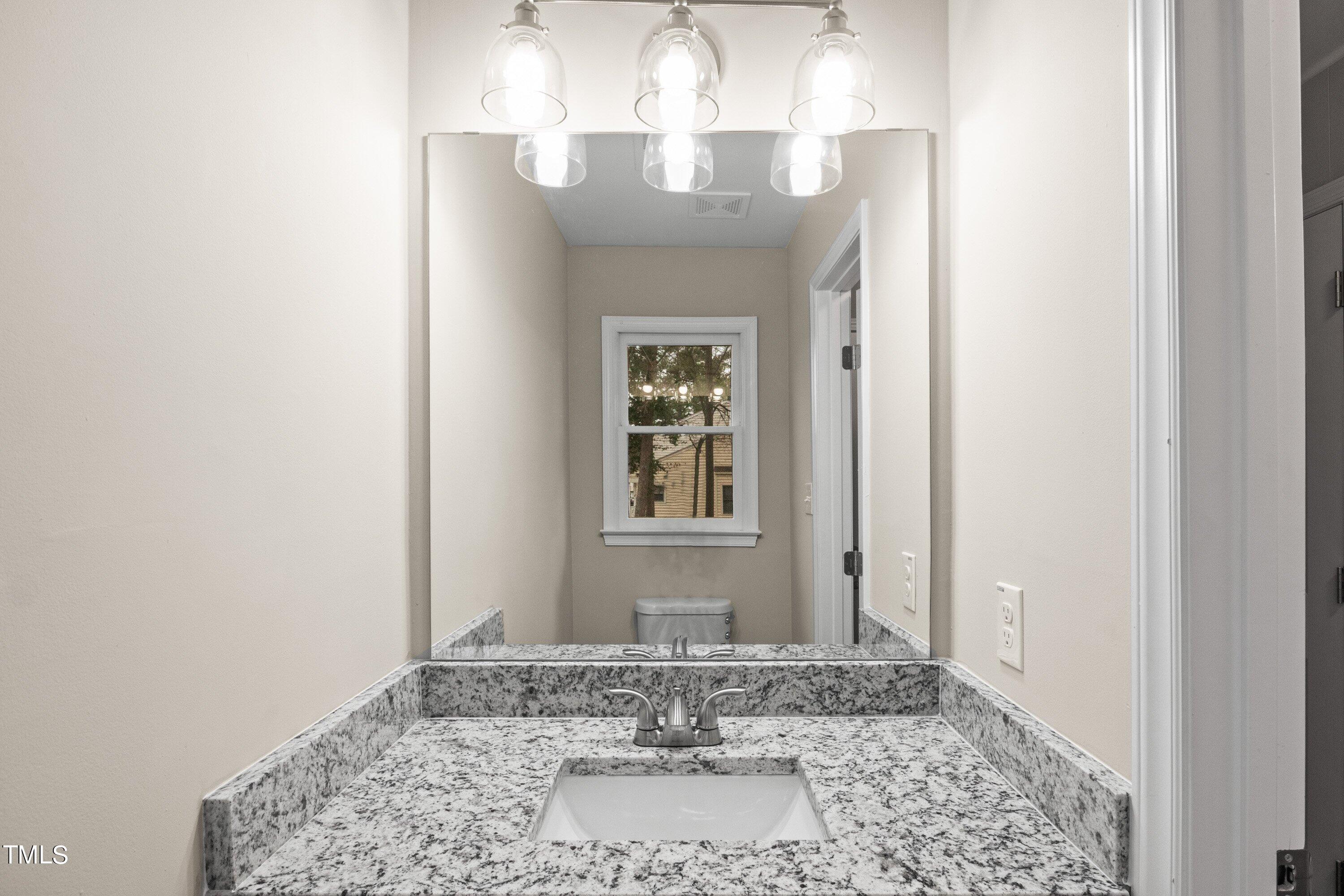 4440 Roller Court Raleigh, NC 27604 - Photo 30 of 38 a view of a bathroom with a chandelier fan and a rug