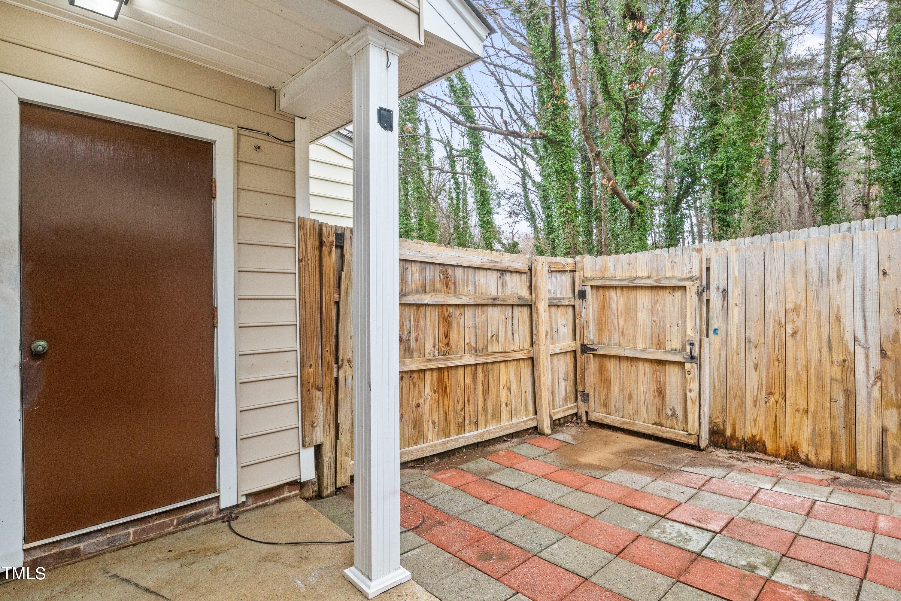 4440 Roller Court Raleigh, NC 27604 - Photo 36 of 38 a view of a wooden house with a large window and wooden fence