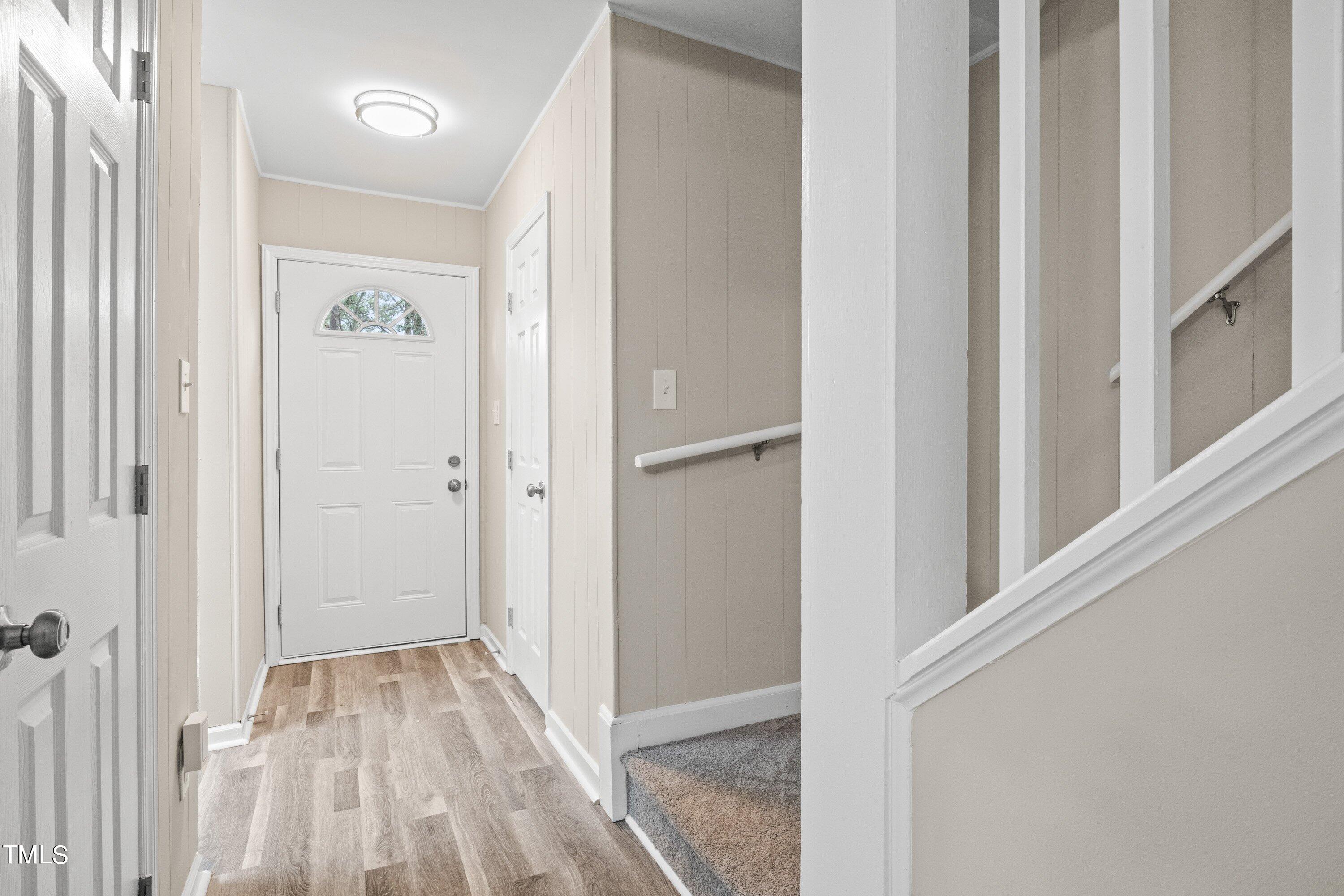 4440 Roller Court Raleigh, NC 27604 - Photo 8 of 38 a view of a hallway with wooden floor and entryway