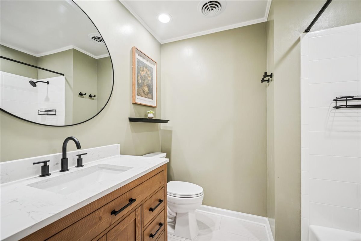 1718 South Ridge Drive Arlington Heights, IL 60005 - Photo 22 of 35 a bathroom with a sink a toilet and mirror