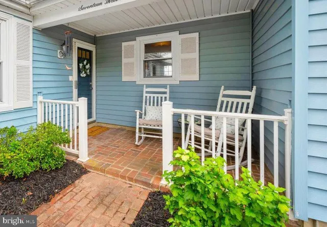 a view of a house with a small yard and flower plants