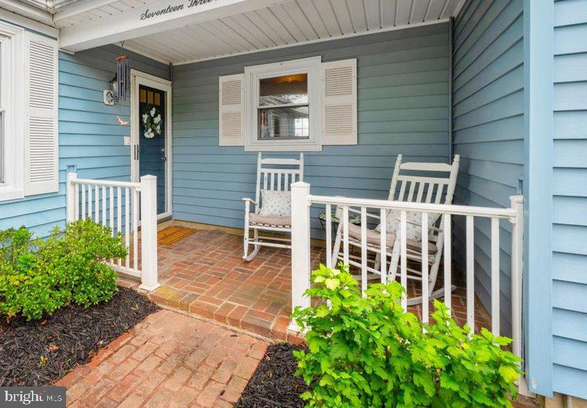 a view of a house with a small yard and flower plants