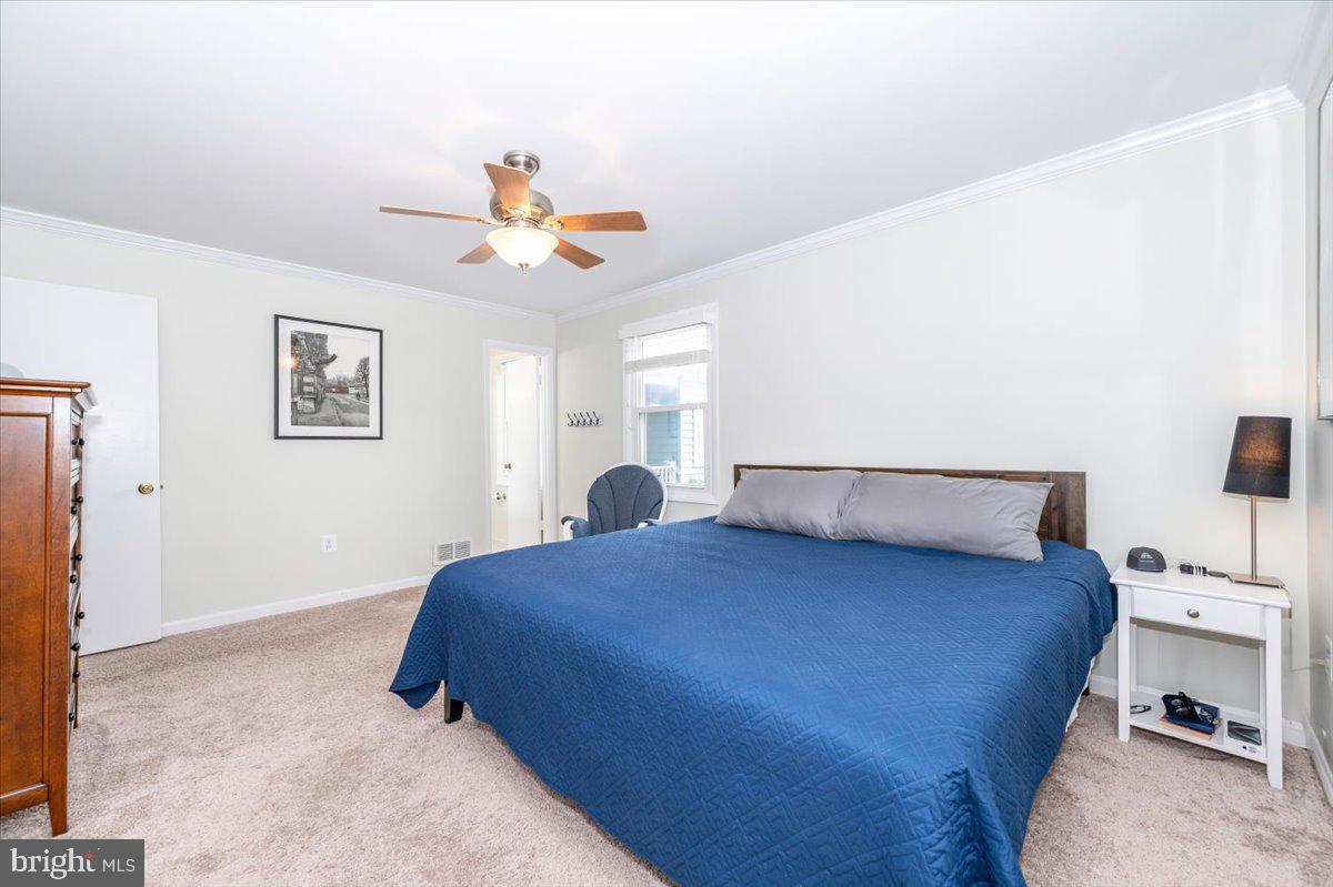 17305 Fletchall Road Poolesville, MD 20837 - Photo 21 of 51 a bedroom with a bed and a chandelier