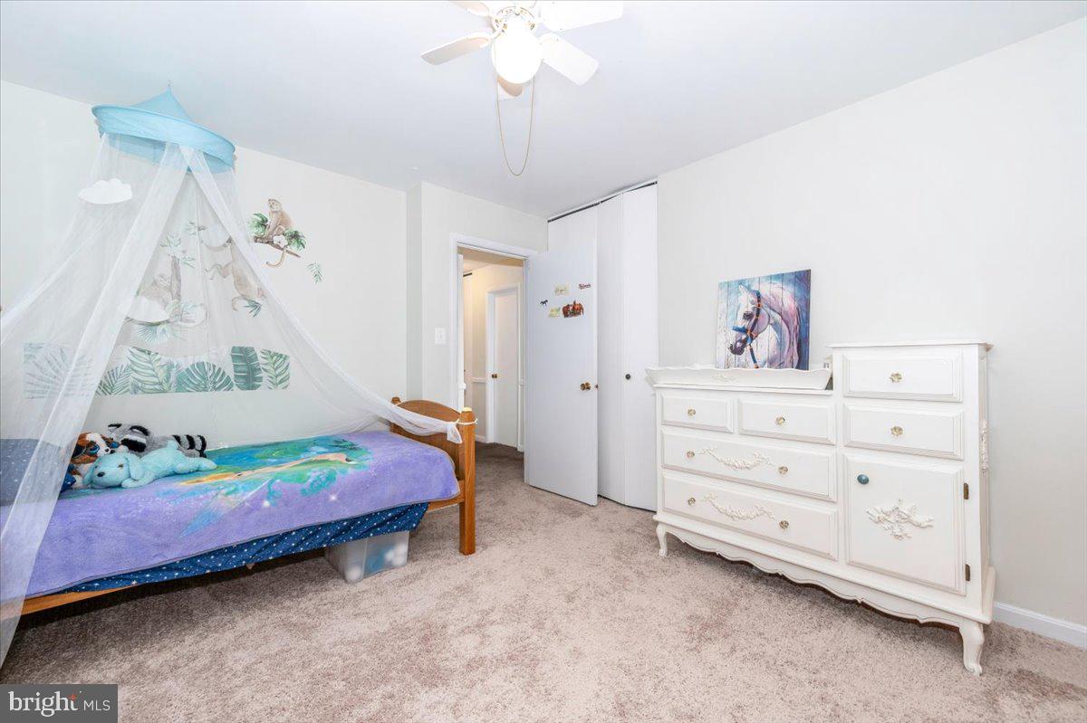 17305 Fletchall Road Poolesville, MD 20837 - Photo 25 of 51 a bedroom with a bed and a chandelier