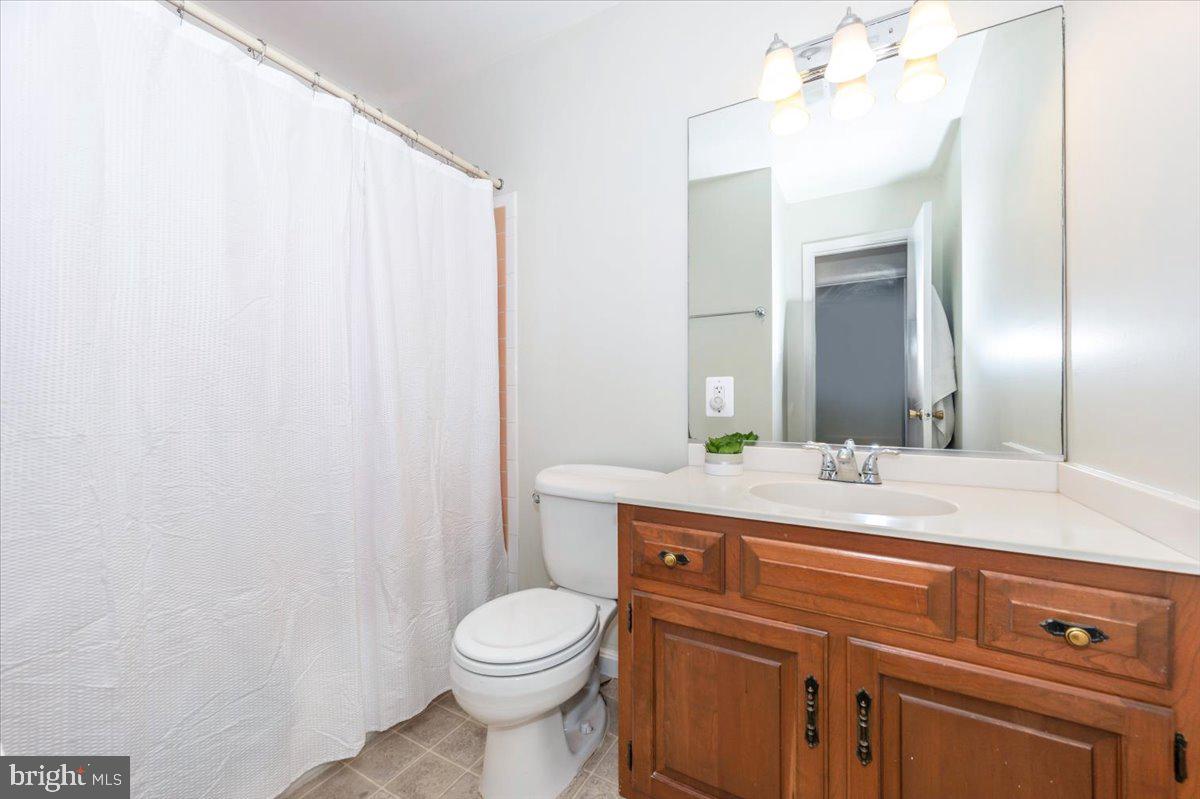 17305 Fletchall Road Poolesville, MD 20837 - Photo 28 of 51 a bathroom with a granite countertop sink a toilet and a mirror