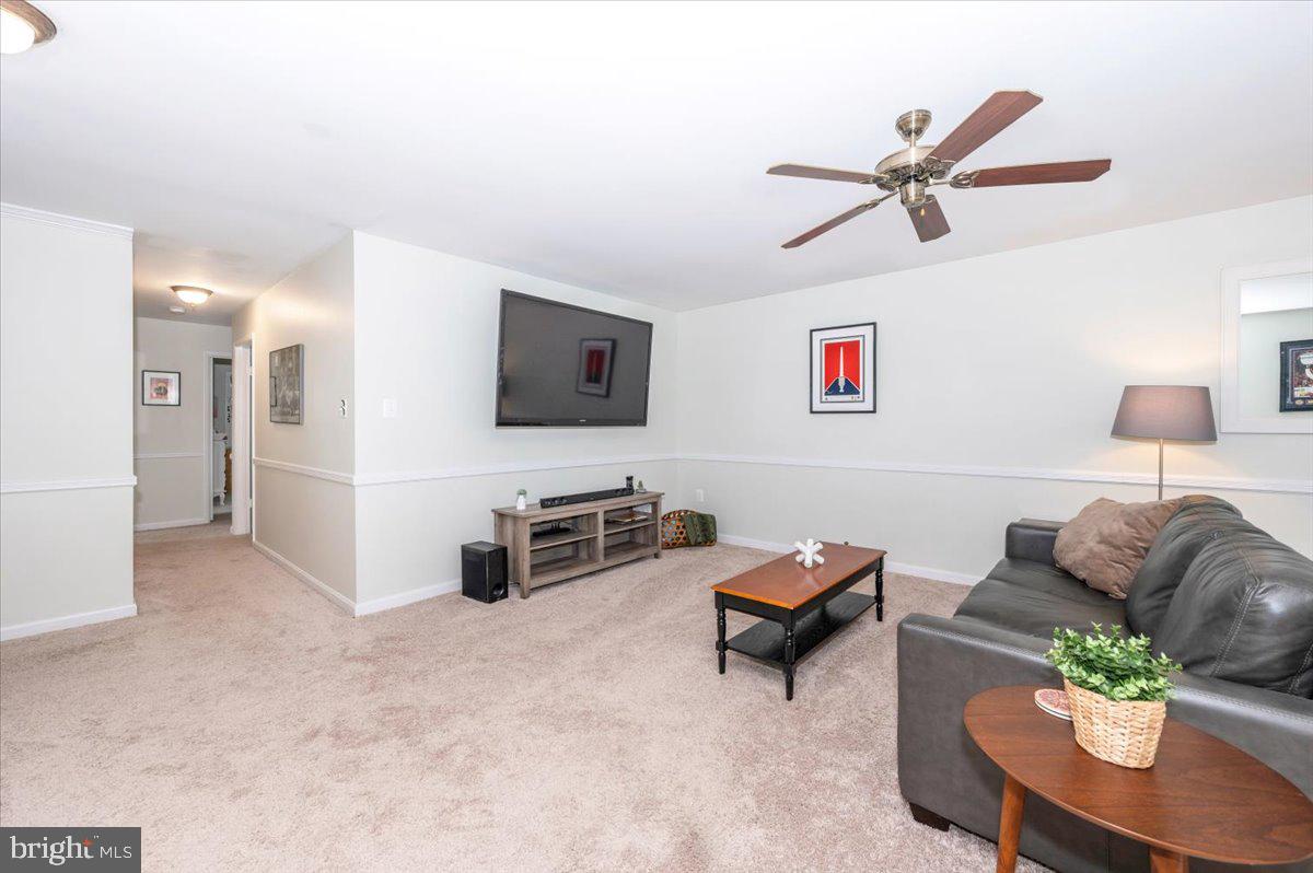 17305 Fletchall Road Poolesville, MD 20837 - Photo 9 of 51 a living room with furniture and a flat screen tv