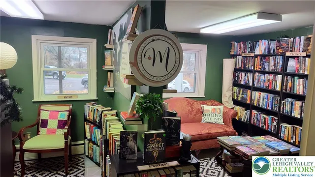 a living room with furniture and a book shelf