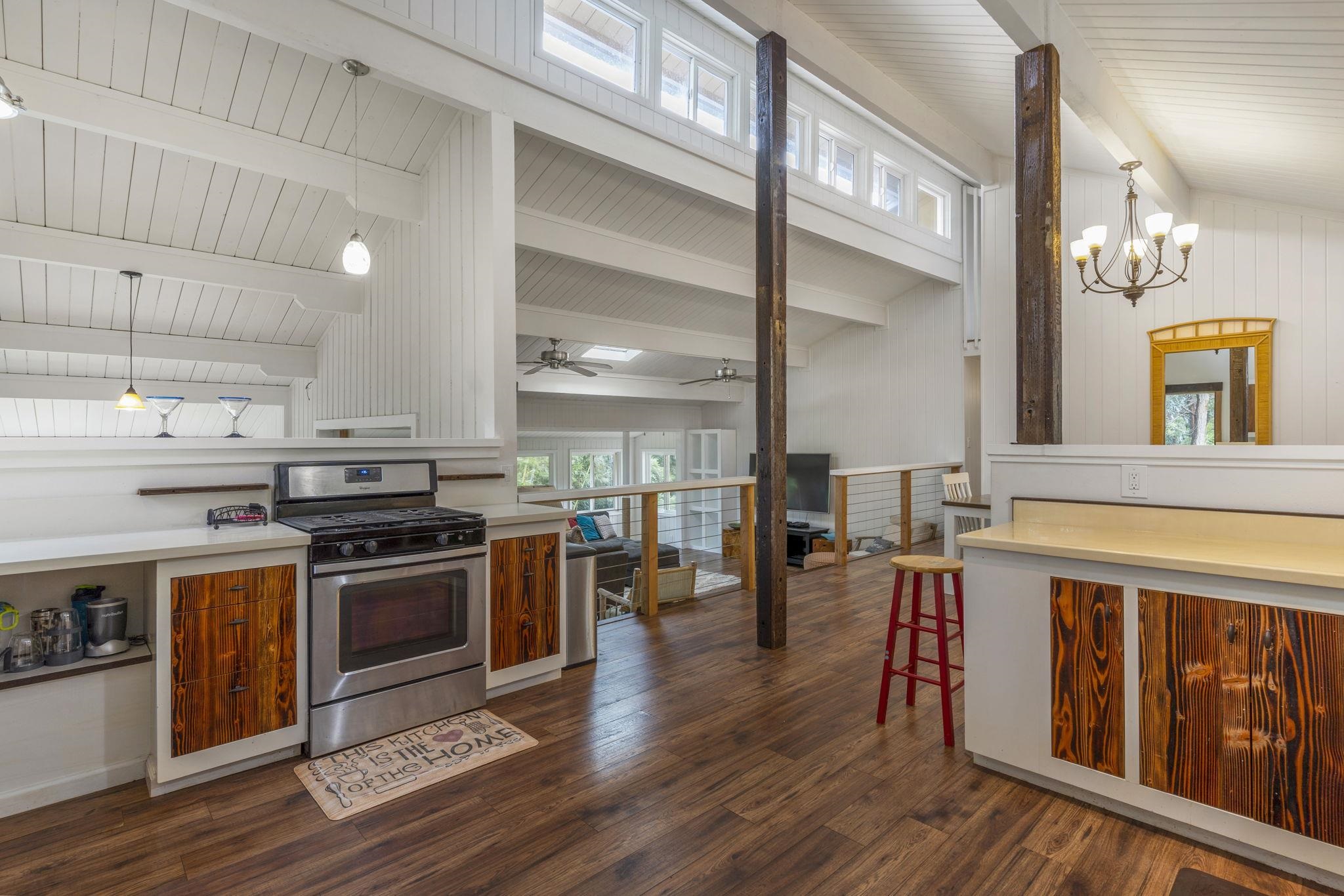 1515 Kaupakalua Road Haiku, HI 96708 - Photo 13 of 45 a kitchen with stainless steel appliances granite countertop a stove and a wooden floors