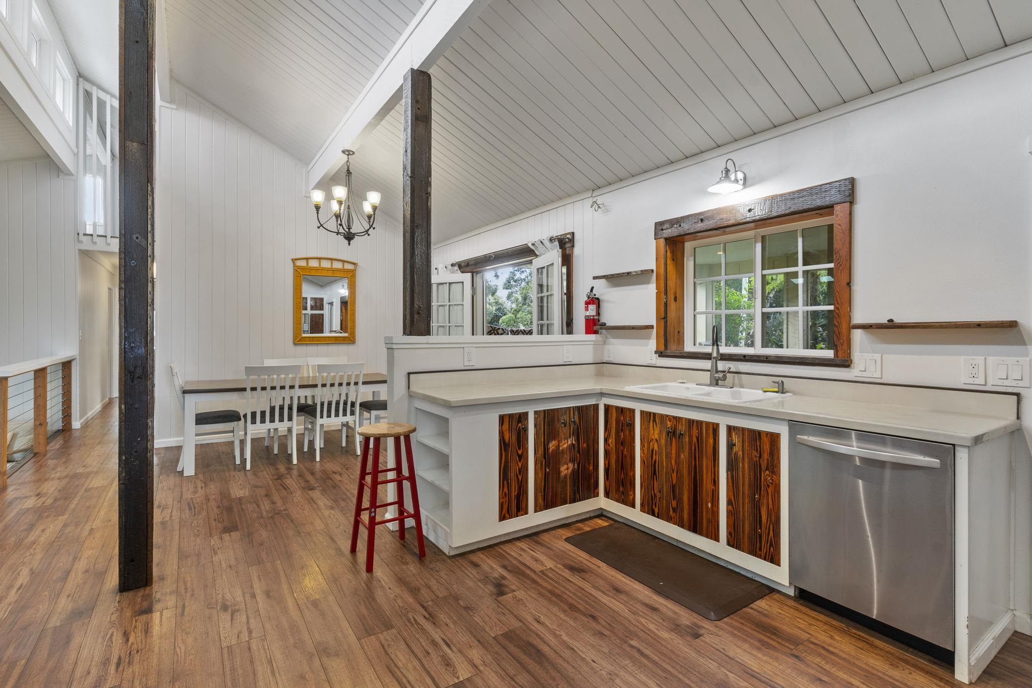 1515 Kaupakalua Road Haiku, HI 96708 - Photo 14 of 45 a kitchen with stainless steel appliances granite countertop a stove and wooden floor