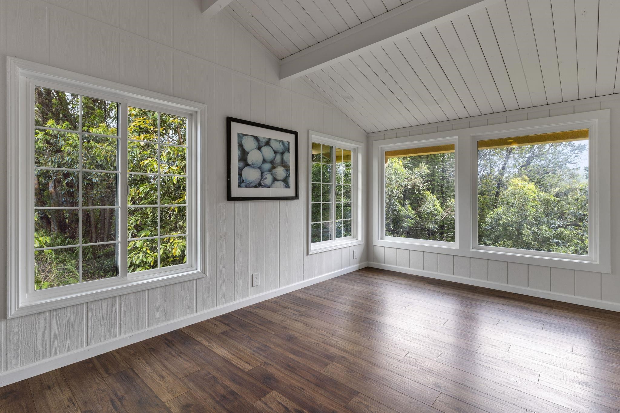 1515 Kaupakalua Road Haiku, HI 96708 - Photo 16 of 45 a view of a hardwood floor in an empty room with a window