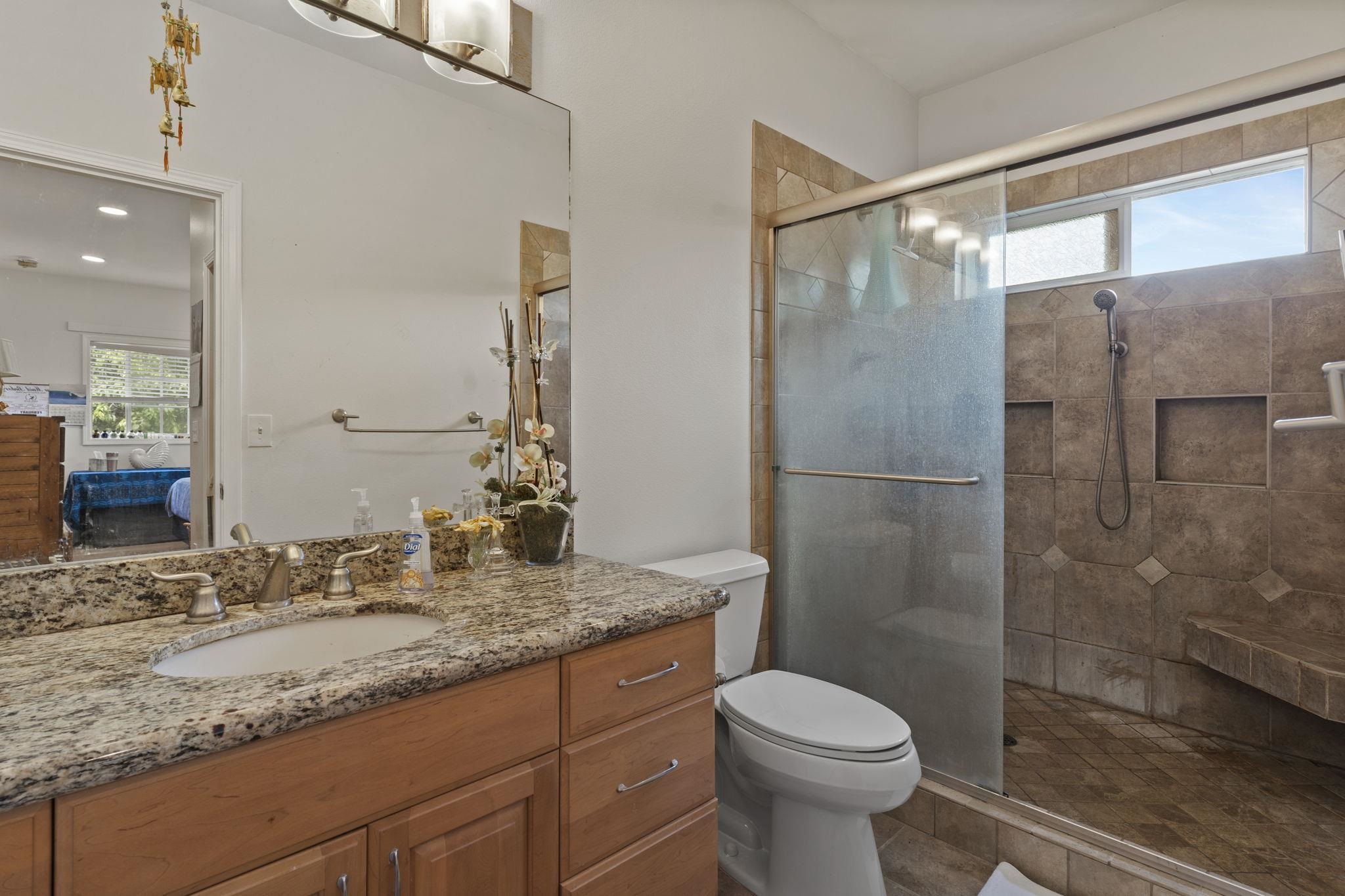 1515 Kaupakalua Road Haiku, HI 96708 - Photo 26 of 45 a bathroom with a granite countertop sink toilet and shower