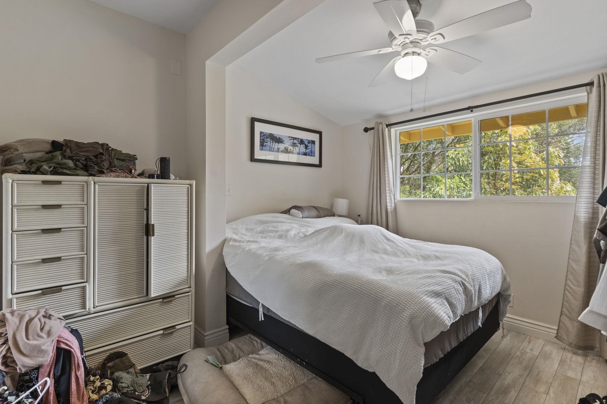 1515 Kaupakalua Road Haiku, HI 96708 - Photo 29 of 45 a bedroom with a bed and a window