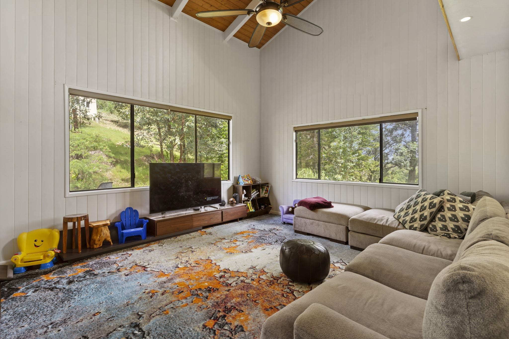 1515 Kaupakalua Road Haiku, HI 96708 - Photo 36 of 45 a living room with furniture a flat screen tv and a large window