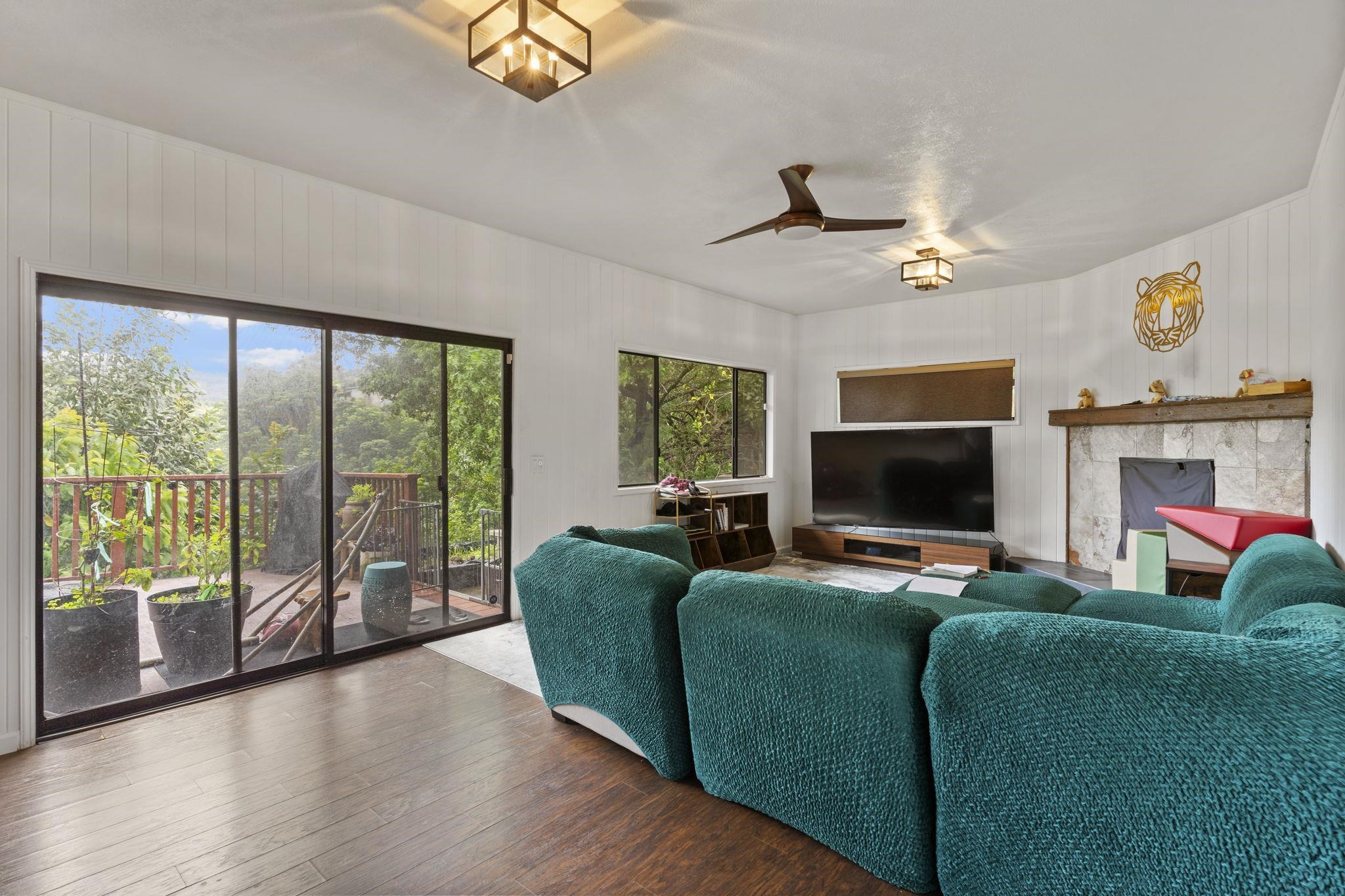 1515 Kaupakalua Road Haiku, HI 96708 - Photo 40 of 45 a living room with furniture a flat screen tv and a fireplace