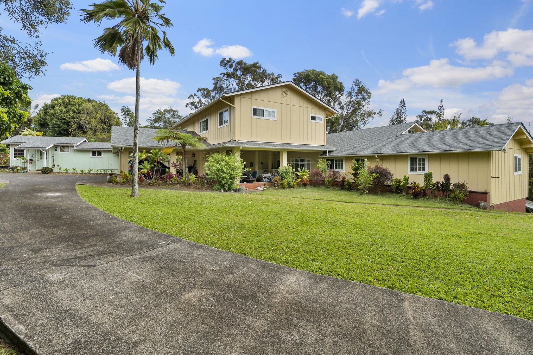 1515 Kaupakalua Road Haiku, HI 96708 - Photo 4 of 45 a view of a house with a big yard and palm trees