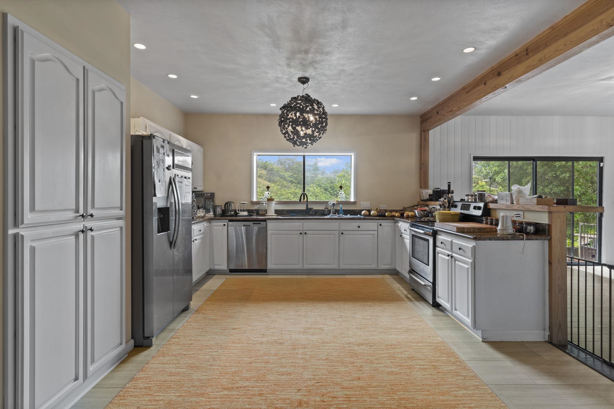 1515 Kaupakalua Road Haiku, HI 96708 - Photo 41 of 45 a large kitchen with stainless steel appliances granite countertop a large counter top a sink and a refrigerator