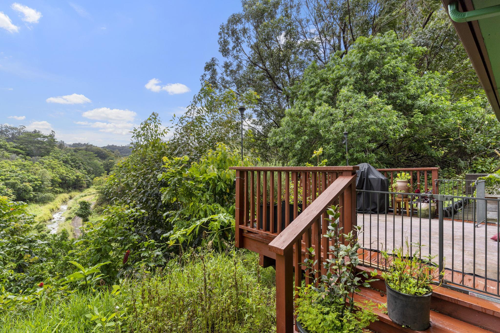1515 Kaupakalua Road Haiku, HI 96708 - Photo 43 of 45 a balcony with wooden fence and trees