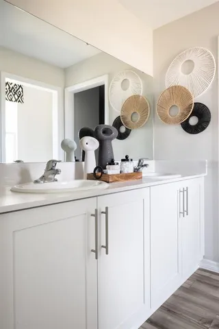 a bedroom with a bed window and flat screen tv