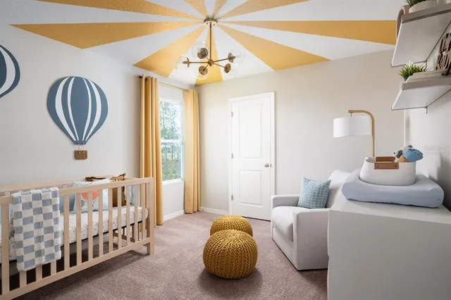 a bedroom with bed and a chandelier