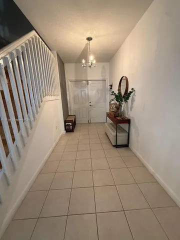 a view of a livingroom with furniture and staircase