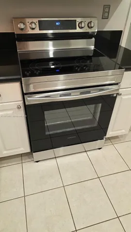 a stove top oven sitting inside of a kitchen