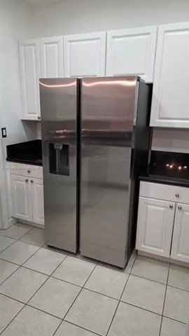 a kitchen with cabinets and stainless steel appliances