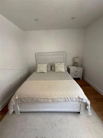 a bedroom with a bed and a lamp
